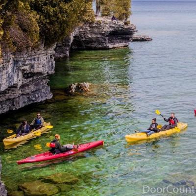 Kayakers paddling toward Cave Point in Wisconsin