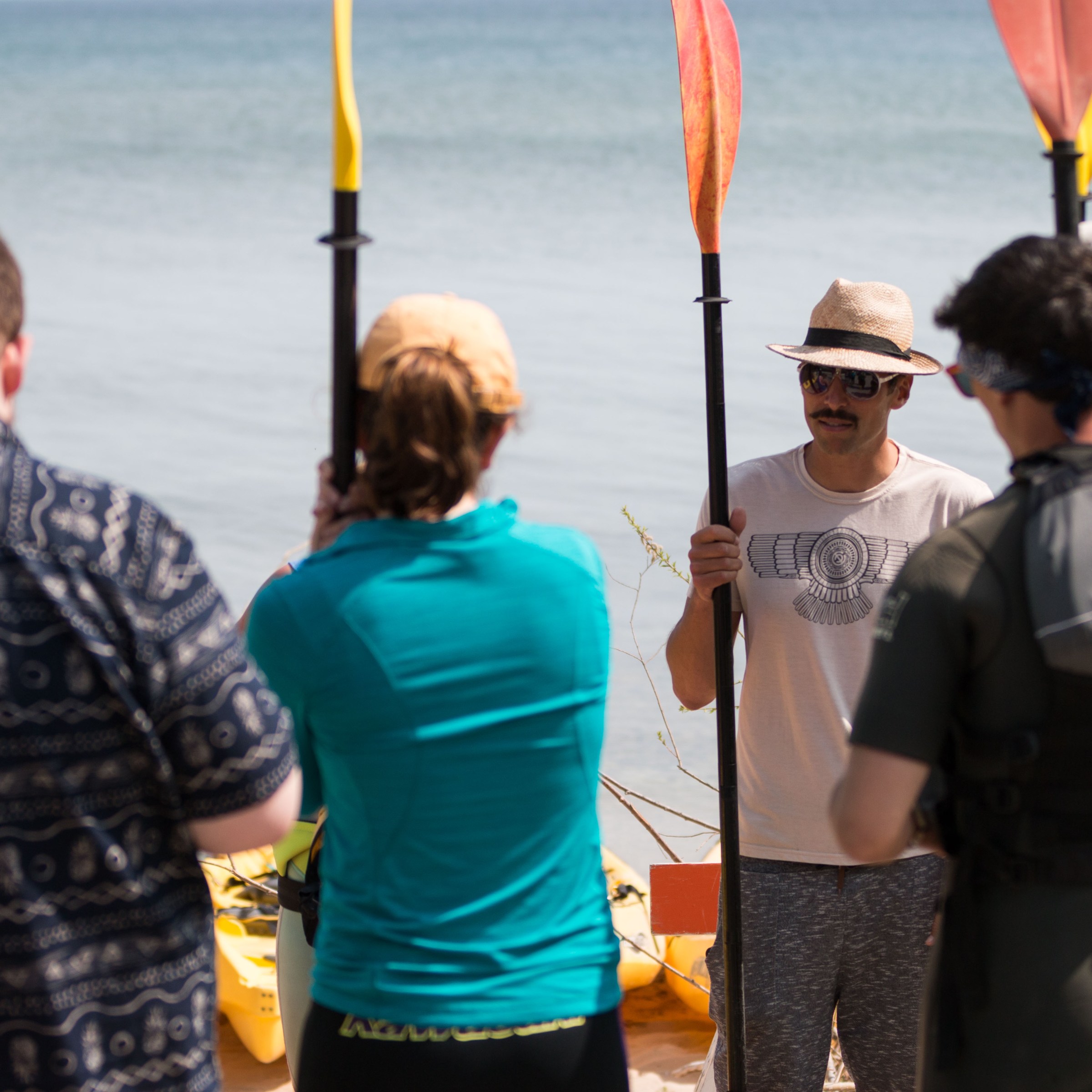 The owner of Door County Kayak Tours speaks to a group of kayakers