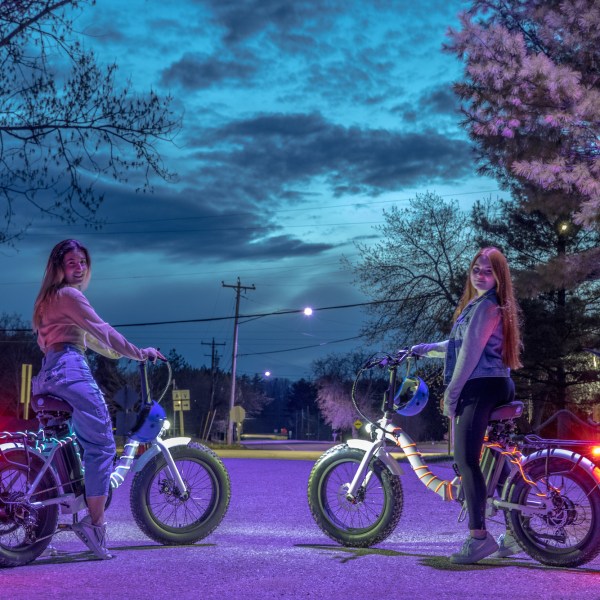 a group of people riding on the back of a bicycle