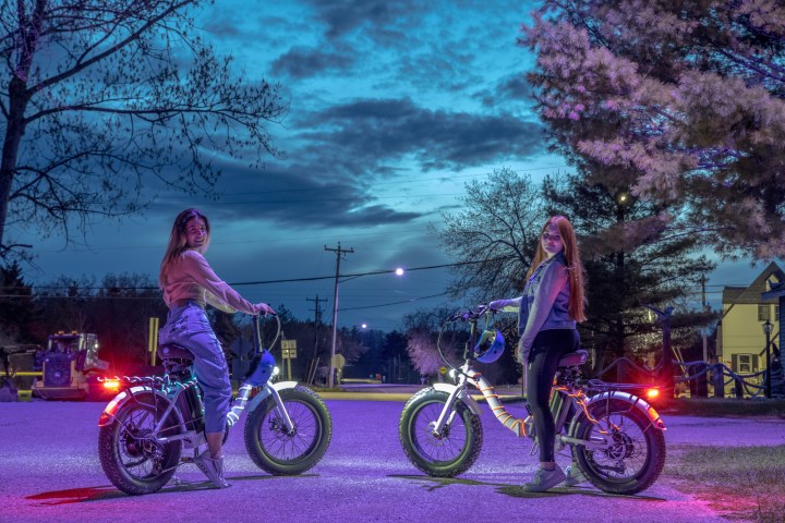 a group of people riding on the back of a bicycle