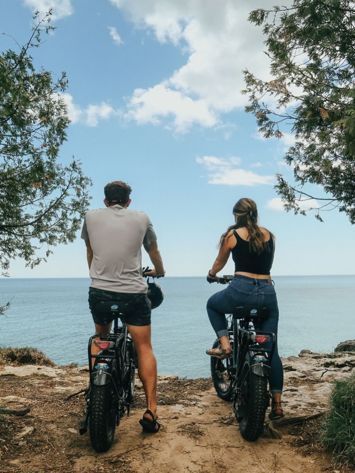 a person riding a motorcycle down a dirt road