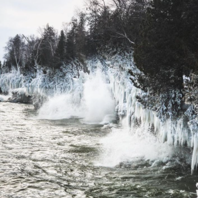 a large waterfall over a body of water
