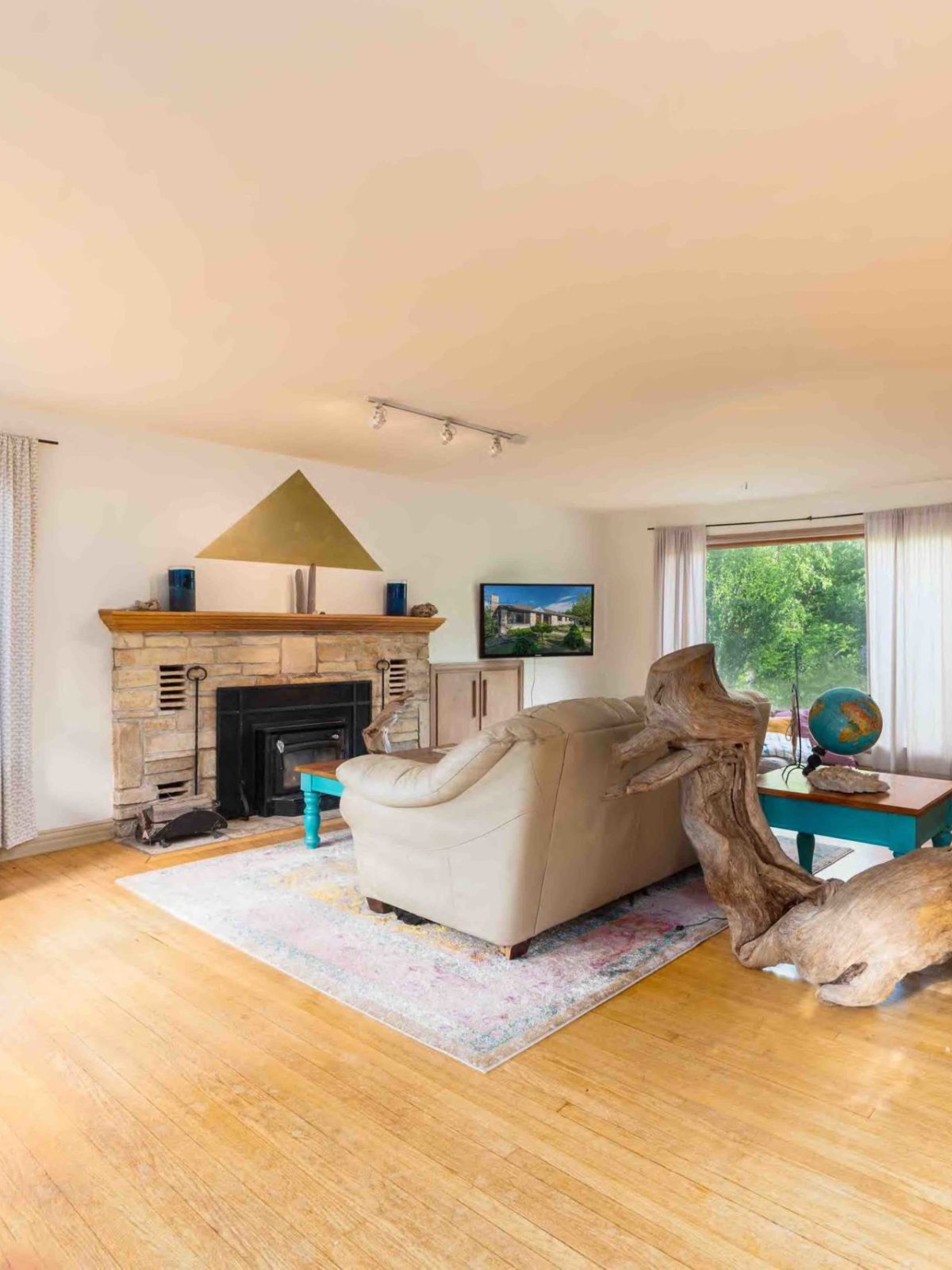 a living room filled with furniture on top of a hard wood floor