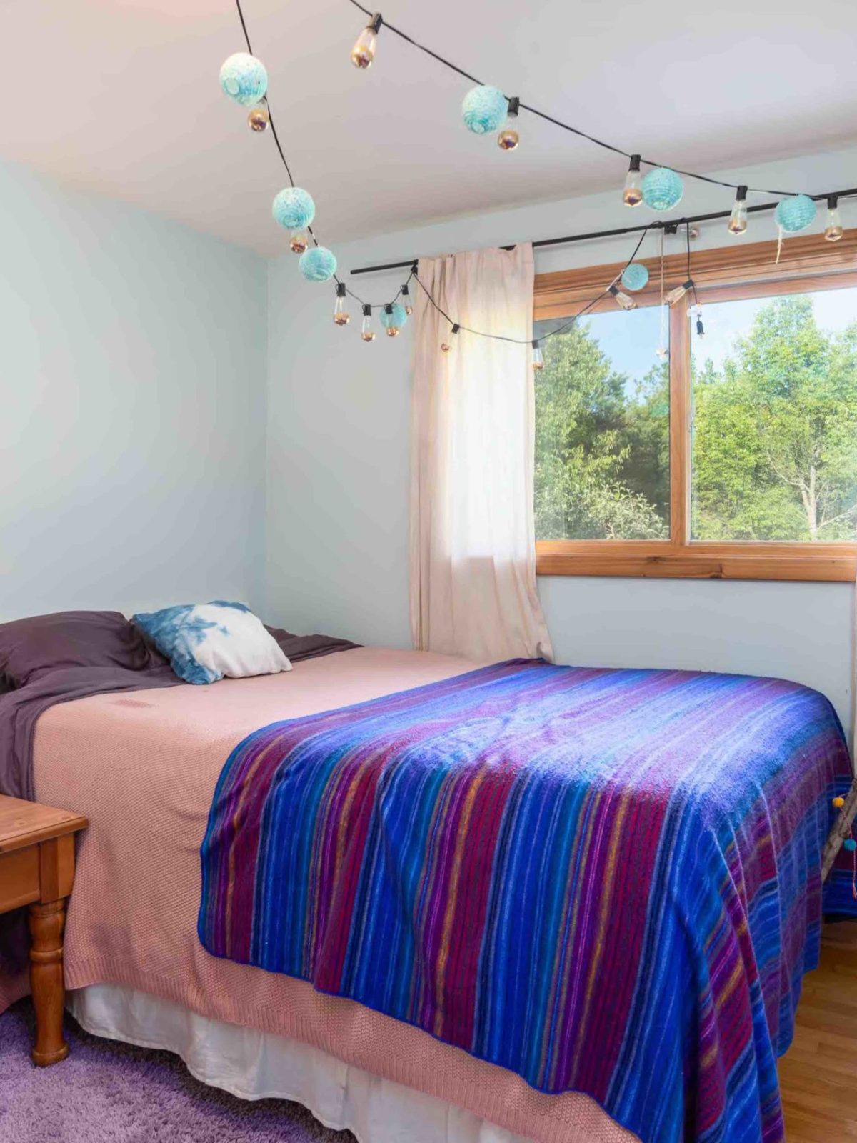 a bedroom with a bed and desk in a small room