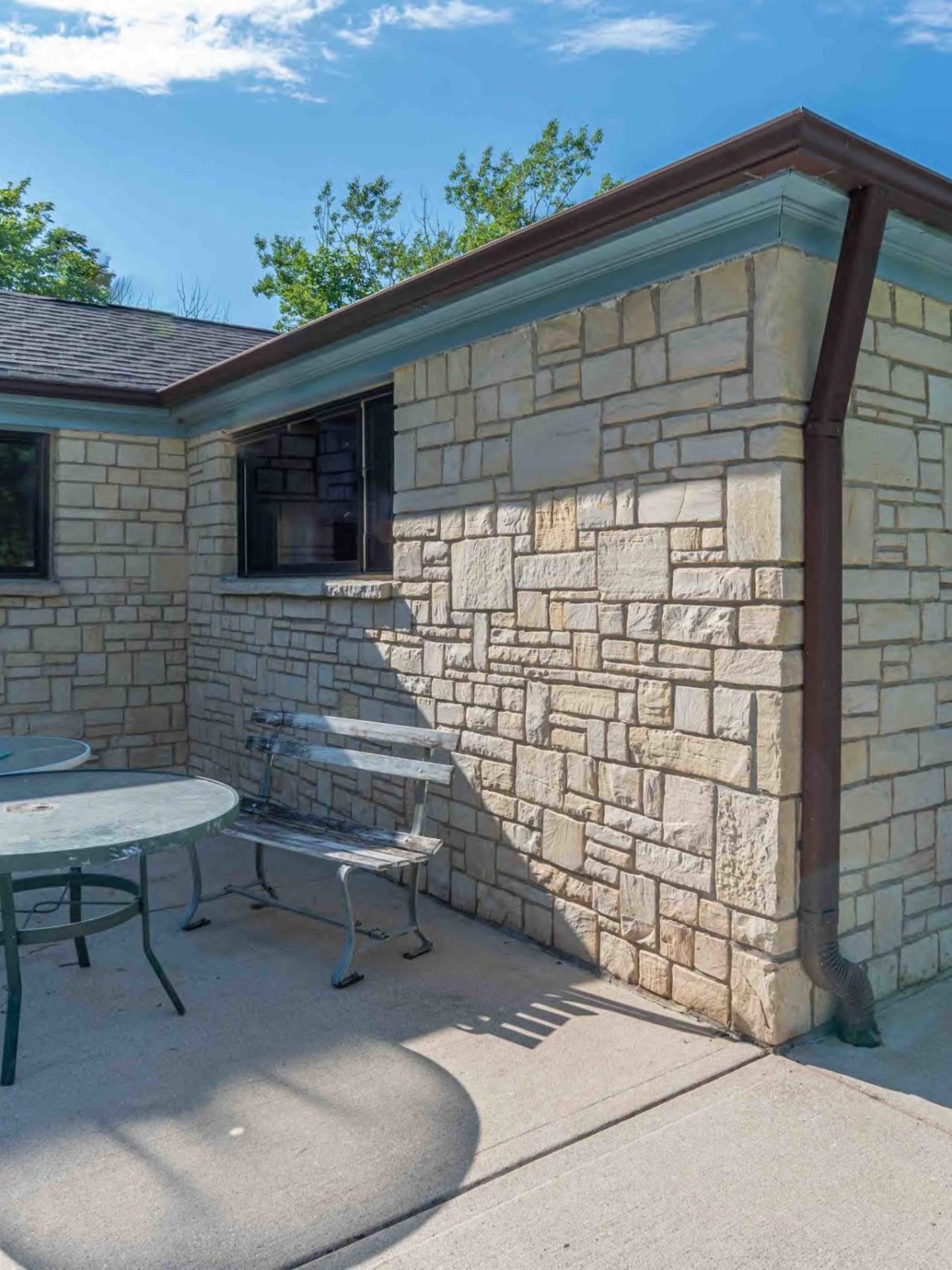 a bench in front of a brick building