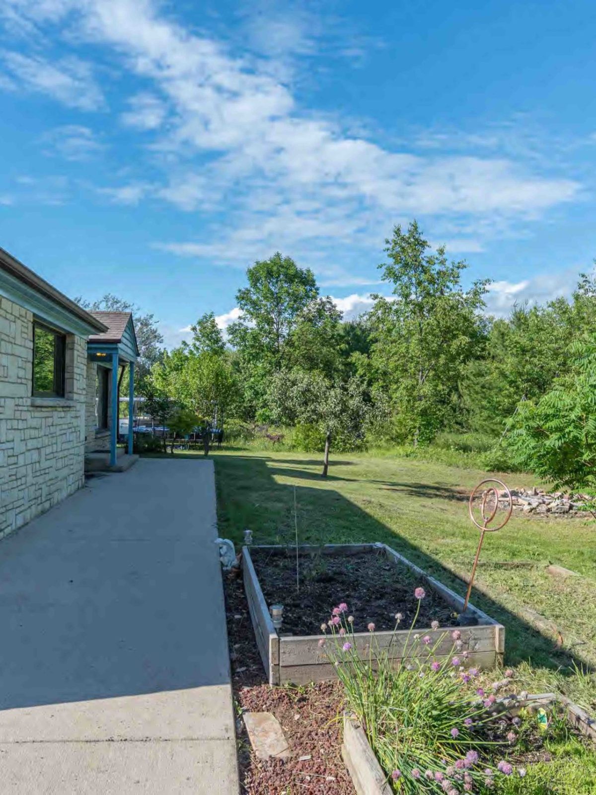 a large brick building with grass and trees