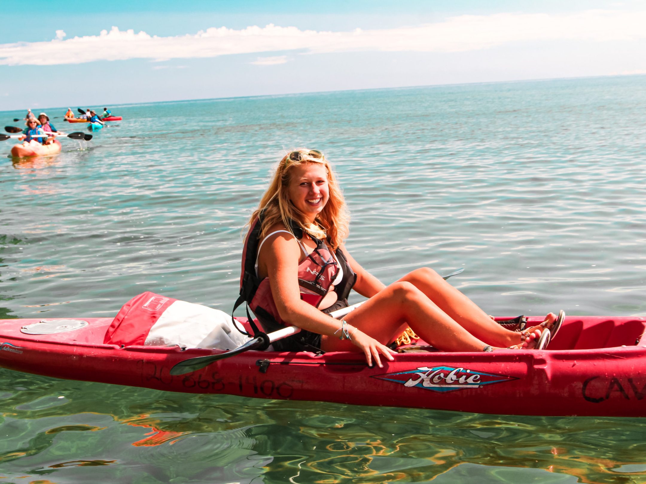 a person riding on the back of a boat in a body of water