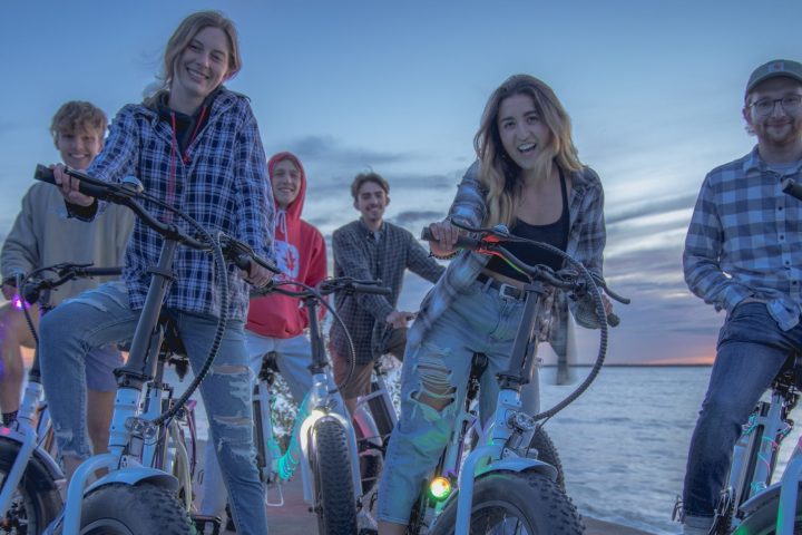 a group of people standing around a motorcycle